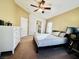 Spacious bedroom featuring a ceiling fan, dresser, and queen sized bed at 6449 Stone Dry Ave # 101, Henderson, NV 89011