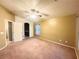 Bedroom with wall to wall carpeting and an arched doorway to the ensuite bathroom at 6449 Stone Dry Ave # 101, Henderson, NV 89011