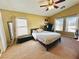 Bedroom featuring a bed, a vaulted ceiling with ceiling fan, and multiple windows for natural light at 6449 Stone Dry Ave # 101, Henderson, NV 89011