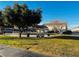 A community picnic area with mature trees and a covered picnic table near a parking area at 6449 Stone Dry Ave # 101, Henderson, NV 89011