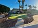 Community putting green with manicured landscaping, mature trees, and a walking path at 6449 Stone Dry Ave # 101, Henderson, NV 89011