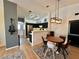 Dining area with a stylish light fixture and a view into the modern kitchen at 6449 Stone Dry Ave # 101, Henderson, NV 89011