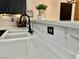 A close-up of the white kitchen sink and countertop with modern black faucet at 6449 Stone Dry Ave # 101, Henderson, NV 89011