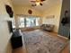 A bright living room with a vaulted ceiling, ceiling fan, and a large rug on the wooden floors at 6449 Stone Dry Ave # 101, Henderson, NV 89011