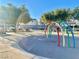 Colorful playground water arches near picnic tables and a park pavilion with bright blue skies at 6449 Stone Dry Ave # 101, Henderson, NV 89011