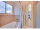 Bathroom features a bathtub, shower, and updated tile at 6617 Old Newbury Ave, Las Vegas, NV 89108