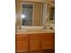 Bathroom with double vanity and wood cabinets at 6617 Old Newbury Ave, Las Vegas, NV 89108