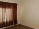 Bedroom with brown curtains and carpet at 6617 Old Newbury Ave, Las Vegas, NV 89108