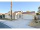 Front view of a single-story house with a large palm tree at 6617 Old Newbury Ave, Las Vegas, NV 89108