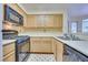 Kitchen features light wood cabinets, black appliances and tile floor at 6617 Old Newbury Ave, Las Vegas, NV 89108