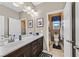 Bathroom featuring a double sink vanity with dark wood cabinets and a separate toilet room at 6914 Willowcroft St, Las Vegas, NV 89149