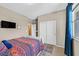 Bedroom with carpet, neutral walls, a window with curtains, and white sliding closet doors at 6914 Willowcroft St, Las Vegas, NV 89149