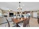 Open dining area with wood table and chairs, adjacent to living room and kitchen at 6914 Willowcroft St, Las Vegas, NV 89149