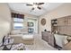 Home office with a built-in desk and cabinets, a sofa, and a window providing natural light at 6914 Willowcroft St, Las Vegas, NV 89149