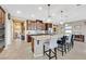 Modern kitchen with island seating, granite countertops, and dark wood cabinets at 6914 Willowcroft St, Las Vegas, NV 89149