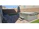 Backyard patio featuring a hot tub with steps and artificial turf at 7050 Fossil Rim St, Las Vegas, NV 89084