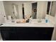 Double vanity bathroom with dark cabinets and a large mirror at 7050 Fossil Rim St, Las Vegas, NV 89084