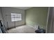 Empty bedroom with neutral walls and a window with blinds at 7050 Fossil Rim St, Las Vegas, NV 89084