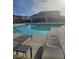 Community pool with lounge chairs, cabanas, and well-maintained landscaping at 7050 Fossil Rim St, Las Vegas, NV 89084
