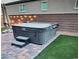 Backyard patio featuring a hot tub with steps and a brick surround at 7050 Fossil Rim St, Las Vegas, NV 89084