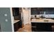 Modern kitchen featuring dark cabinets, granite countertops, and stainless steel refrigerator at 7050 Fossil Rim St, Las Vegas, NV 89084