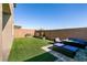 Artificial turf backyard with patio furniture and fire pit at 7122 Rocket Launch St, North Las Vegas, NV 89084