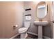 Small bathroom with pedestal sink and oval mirror at 7122 Rocket Launch St, North Las Vegas, NV 89084