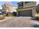 Brick paver driveway leading to a two-car garage at 7122 Rocket Launch St, North Las Vegas, NV 89084