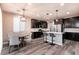 Modern kitchen with dark cabinets and island seating at 7122 Rocket Launch St, North Las Vegas, NV 89084