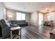 Open living room with gray sectional sofa and dining area at 7122 Rocket Launch St, North Las Vegas, NV 89084