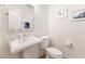 Clean bathroom with pedestal sink and white toilet at 7307 Iron Oak Ave, Las Vegas, NV 89113