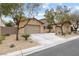 Two-car garage, attractive landscaping, and a charming facade at 7307 Iron Oak Ave, Las Vegas, NV 89113