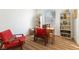 Home office with wood desk, red chair, and built-in shelves at 7307 Iron Oak Ave, Las Vegas, NV 89113