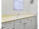 Laundry room with white cabinets and a utility sink at 7307 Iron Oak Ave, Las Vegas, NV 89113