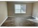 Living room with wood-look flooring and large window at 8101 W Flamingo Rd # 1112, Las Vegas, NV 89147