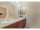 Bathroom with double vanity, mirror, and light brown cabinets at 8157 Amy Springs St, Las Vegas, NV 89113