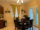 Bright dining area with a round table and four chairs, near the kitchen at 8157 Amy Springs St, Las Vegas, NV 89113