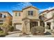 Two-story house with tan siding, attached garage, and landscaping at 8157 Amy Springs St, Las Vegas, NV 89113