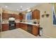 Kitchen with dark wood cabinets and black appliances at 8157 Amy Springs St, Las Vegas, NV 89113