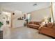 Living room with tile floors, brown couch and access to dining area at 8157 Amy Springs St, Las Vegas, NV 89113