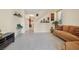 Living room with tile floors, brown couch, and view of staircase at 8157 Amy Springs St, Las Vegas, NV 89113