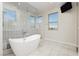 Elegant bathroom featuring a soaking tub, glass shower, and marble flooring at 8224 Skye Territory St, Las Vegas, NV 89166