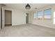 A spacious bedroom is bathed in natural light from the large picture windows overlooking the desert landscape at 8224 Skye Territory St, Las Vegas, NV 89166