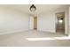 A large, carpeted bedroom bathed in sunlight includes views into the bathroom and out of the large picture windows at 8224 Skye Territory St, Las Vegas, NV 89166