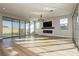 Spacious living room featuring hardwood floors, fireplace, and large windows at 8224 Skye Territory St, Las Vegas, NV 89166