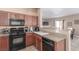 Well-equipped kitchen with wood cabinets and granite countertops at 8985 S Durango Dr # 2047, Las Vegas, NV 89113