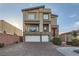 Modern home exterior with a two-car garage and landscaping at 9045 Knots Estate St, Las Vegas, NV 89139