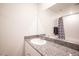 Modern bathroom with granite countertop and large mirror at 9131 Hitmaker St, Las Vegas, NV 89113