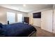 Well-lit bedroom with a king-size bed and private access at 9131 Hitmaker St, Las Vegas, NV 89113