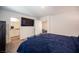 Comfortable bedroom with ensuite bathroom and large TV at 9131 Hitmaker St, Las Vegas, NV 89113